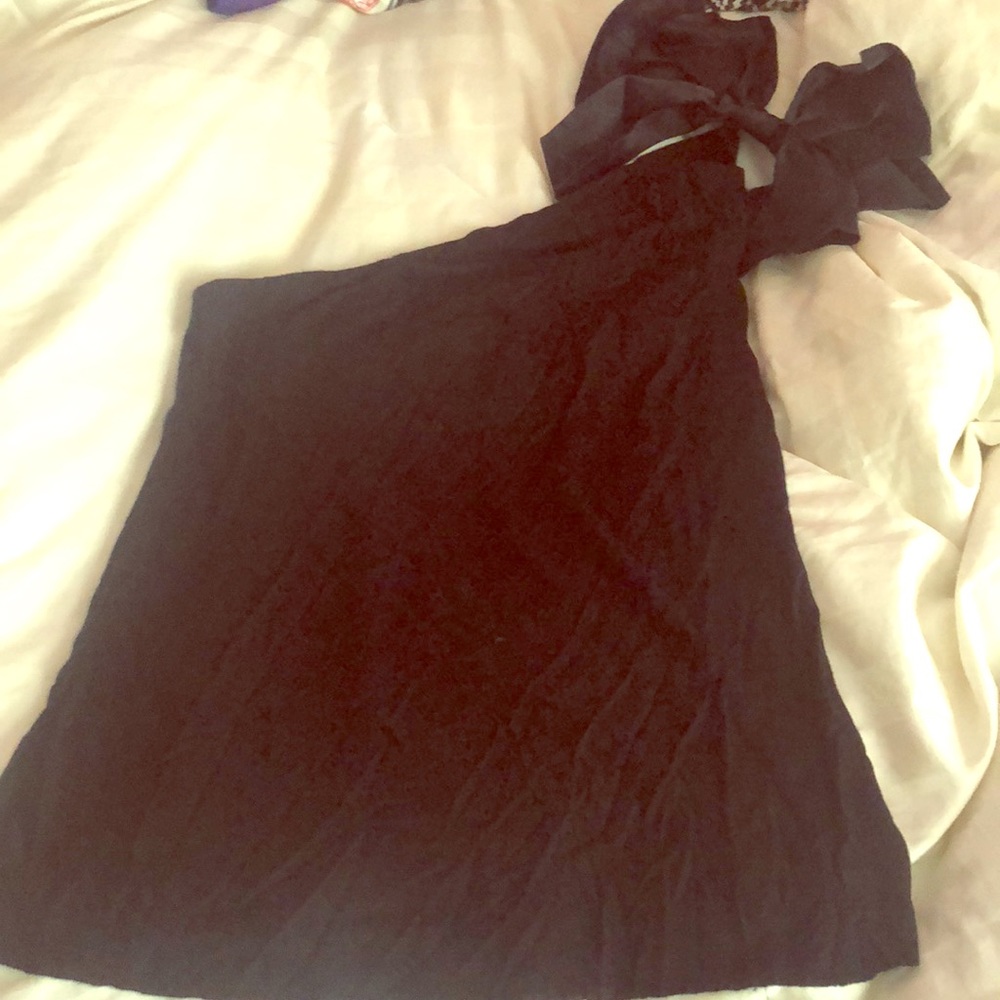 One shoulder black top with a satin bow